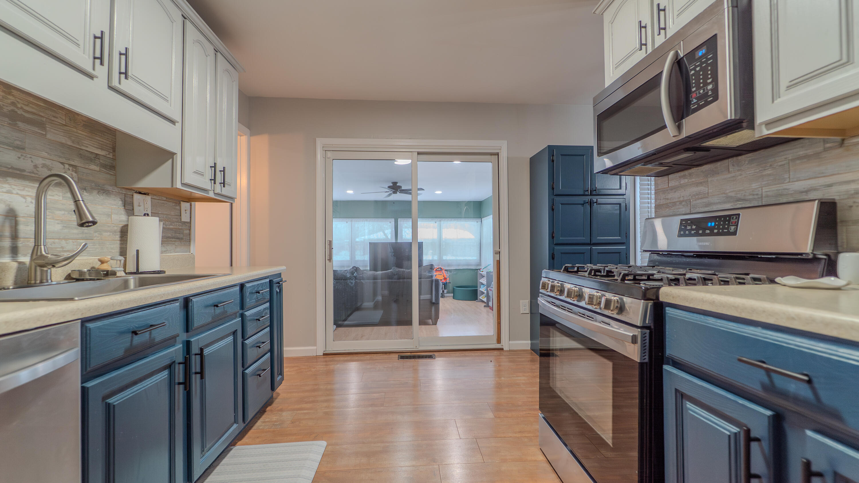 2934 Parker Street Portage, IN 46368 - Photo 9 of 16 a kitchen with stainless steel appliances a stove top oven a sink and a refrigerator