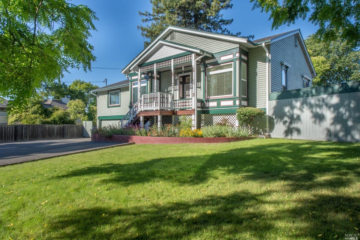 a view of a house with a yard and sitting area