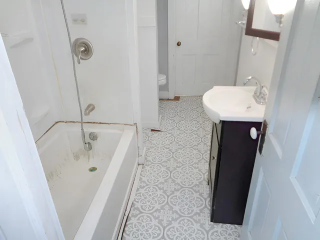 a bathroom with a sink and mirror