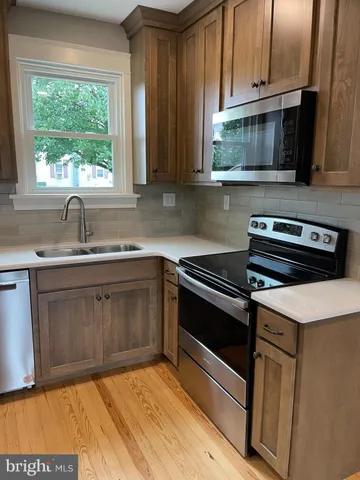 a kitchen with a sink stove and microwave