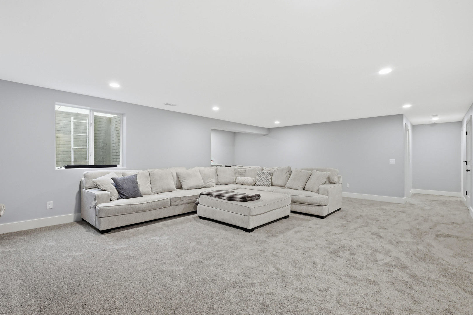 6779 Genesis Way Bettendorf, IA 52722 - Photo 27 of 36 a living room with furniture and a large window