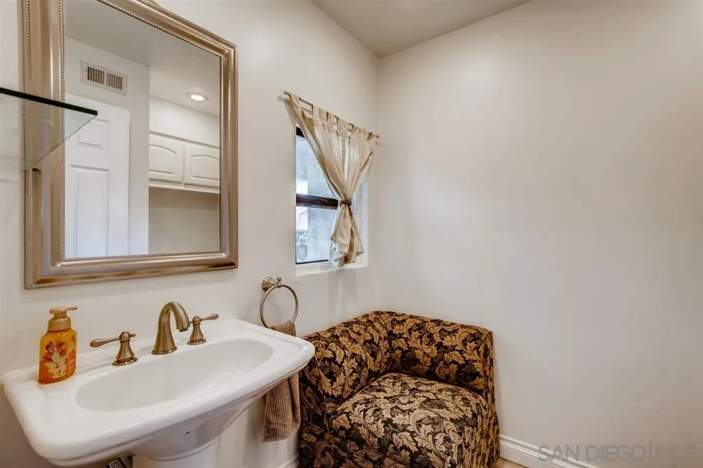 1913 Alga Road Carlsbad, CA 92009 - Photo 11 of 25 a bathroom with a sink and a mirror