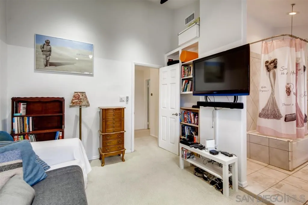 1913 Alga Road Carlsbad, CA 92009 - Photo 17 of 25 a living room with furniture and a flat screen tv