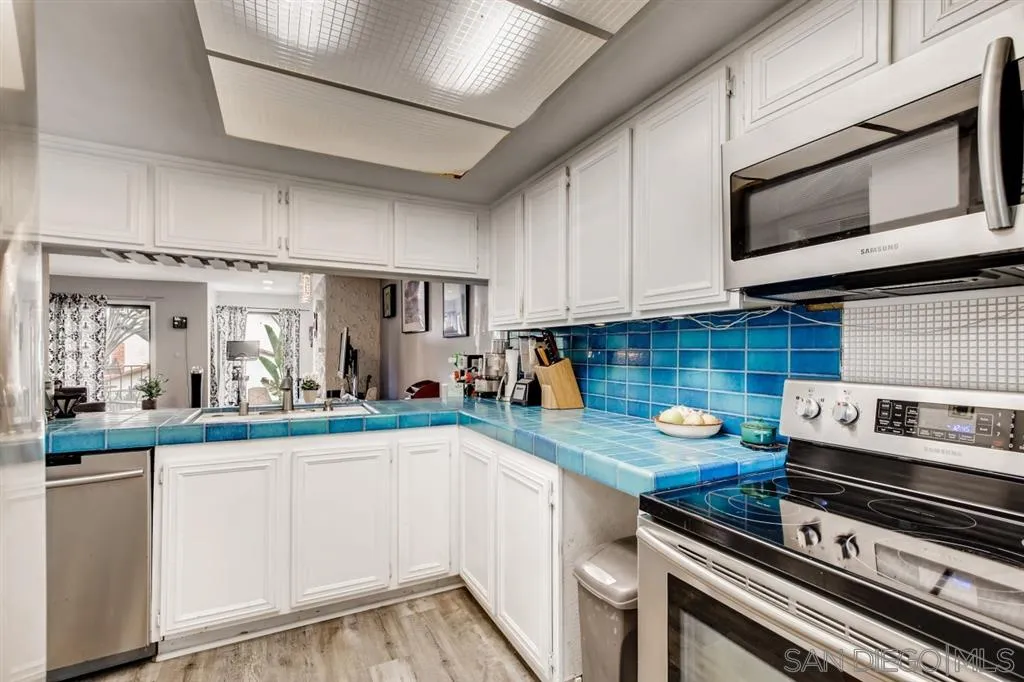1913 Alga Road Carlsbad, CA 92009 - Photo 9 of 25 a kitchen with appliances a sink and cabinets