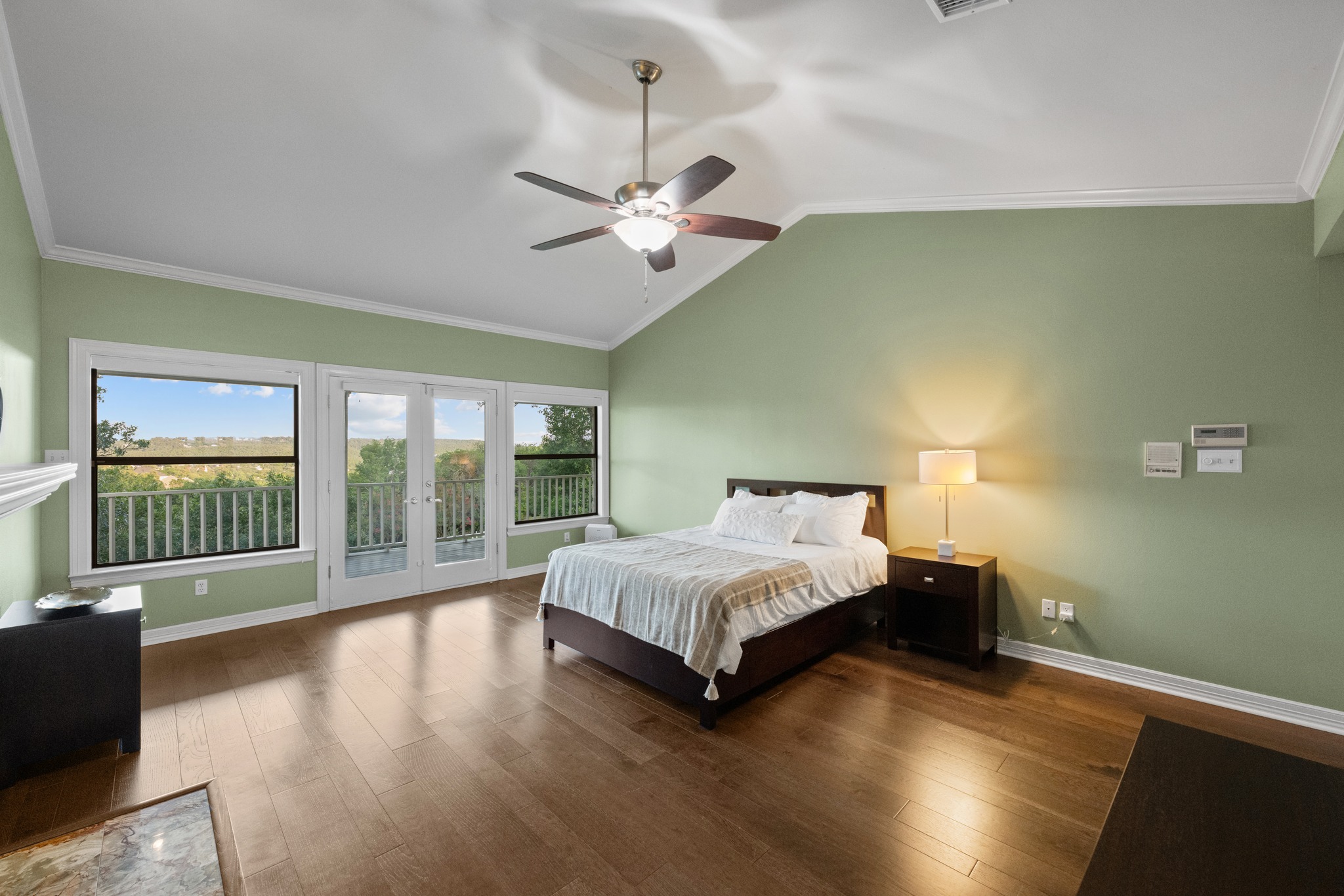 6004 Mt Bonnell Road Austin, TX 78731 - Photo 14 of 24 a spacious bedroom with a bed and wooden floor