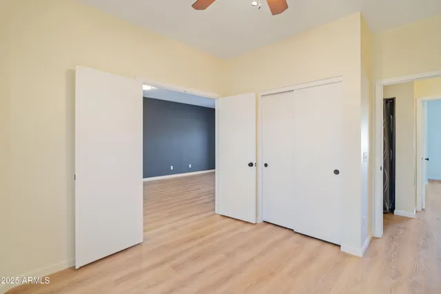 a view of an empty room with cabinet and a window