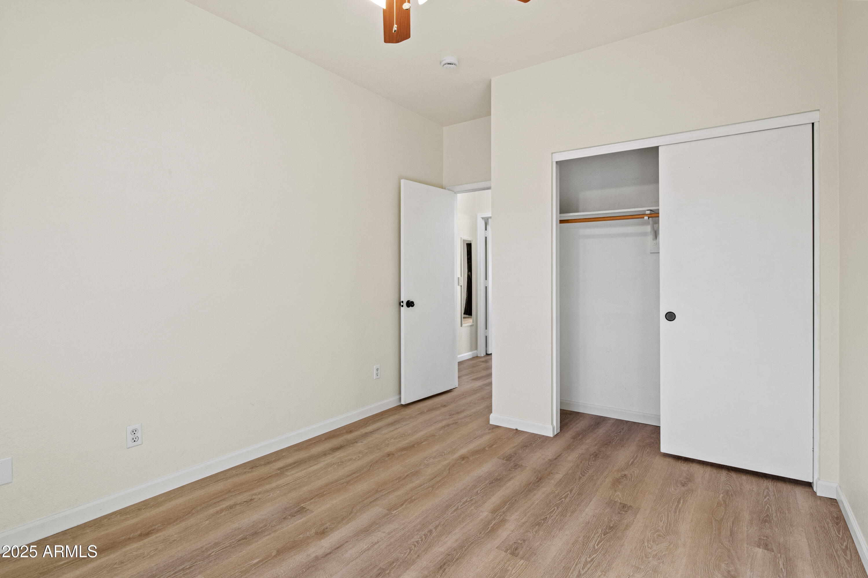 625 North Hamilton Street, Unit 41 Chandler, AZ 85225 - Photo 27 of 36 a view of an empty room with wooden floor and closet
