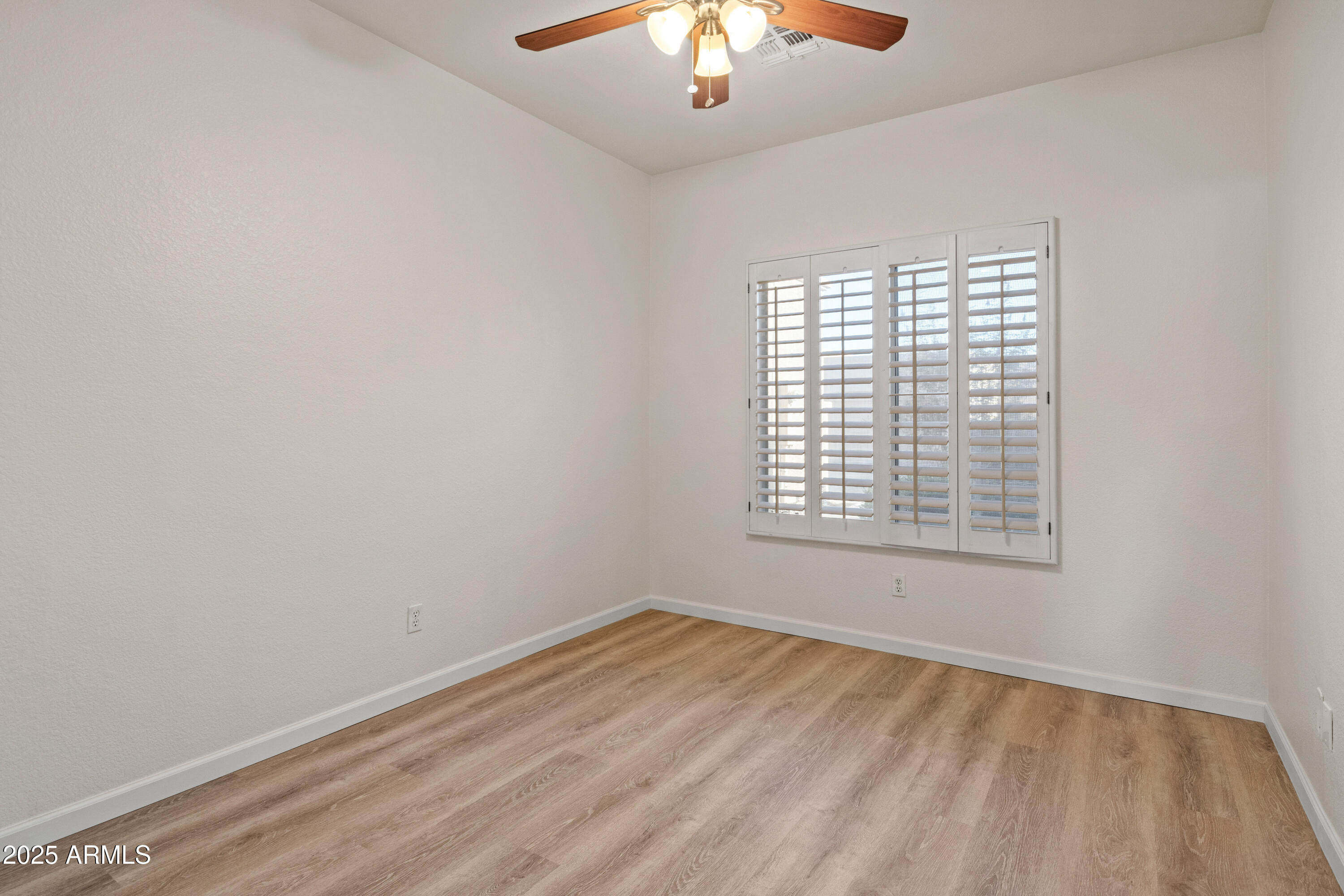 625 North Hamilton Street, Unit 41 Chandler, AZ 85225 - Photo 28 of 36 a view of an empty room with wooden floor and a window