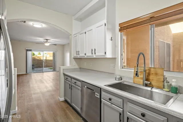 a kitchen with a sink cabinets and window