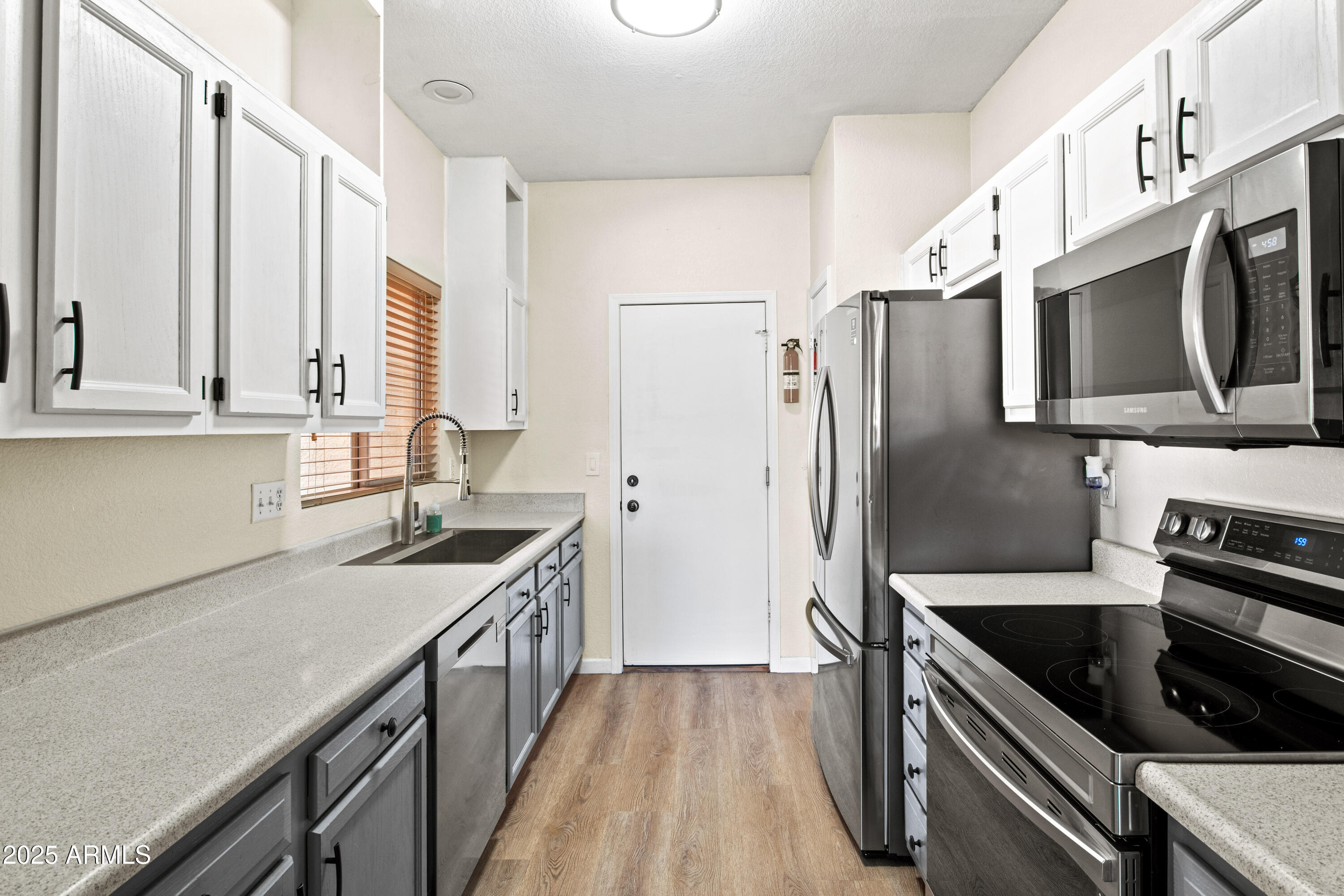 625 North Hamilton Street, Unit 41 Chandler, AZ 85225 - Photo 9 of 36 a kitchen with stainless steel appliances a stove a sink a refrigerator and cabinets