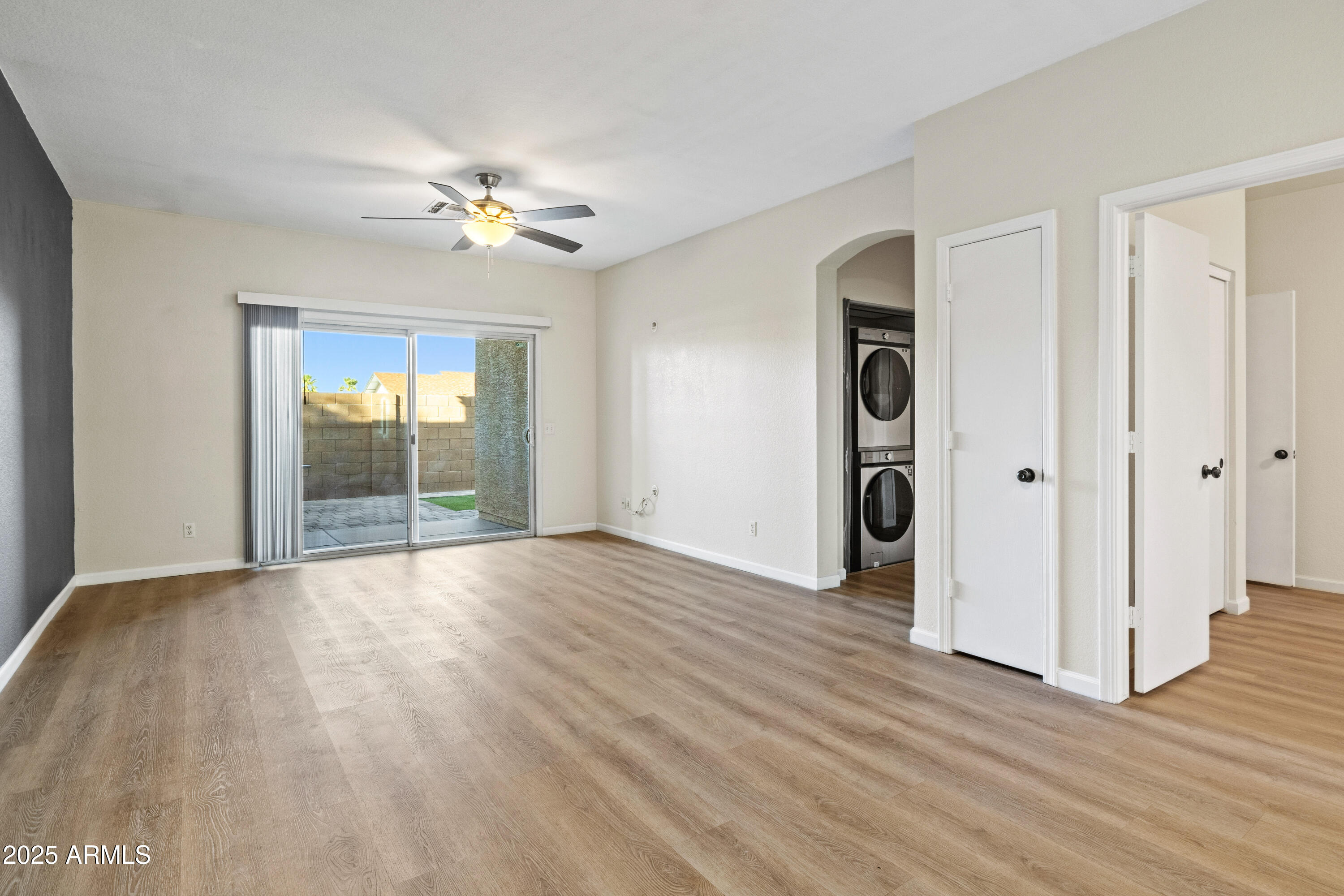 625 North Hamilton Street, Unit 41 Chandler, AZ 85225 - Photo 10 of 36 an empty room with wooden floor chandelier fan and windows