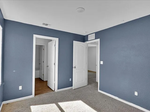 a view of an empty room and bathroom