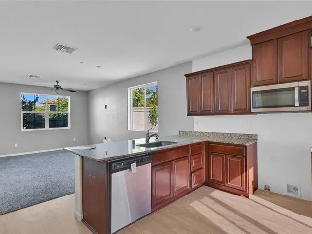 a kitchen with a sink stove and microwave