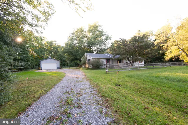 a front view of house with yard and trees