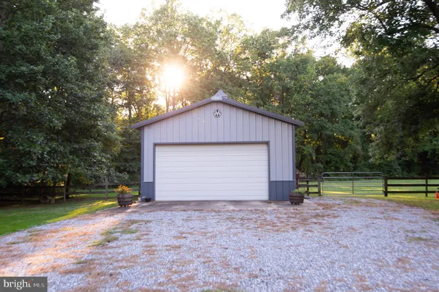 a view of a green field with wooden fence