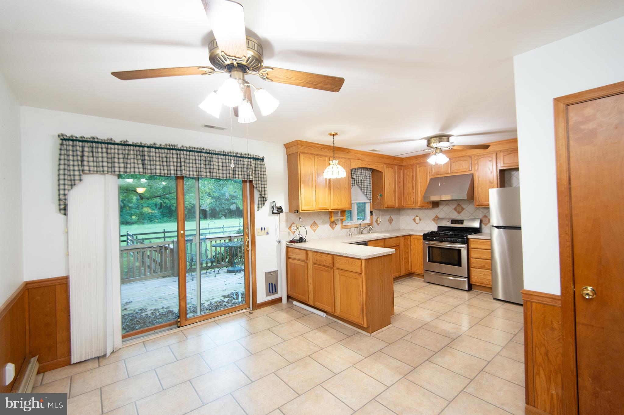 11482 Kittys Corner Road Cordova, MD 21625 - Photo 38 of 68 a large kitchen with granite countertop a large counter top space appliances and cabinets