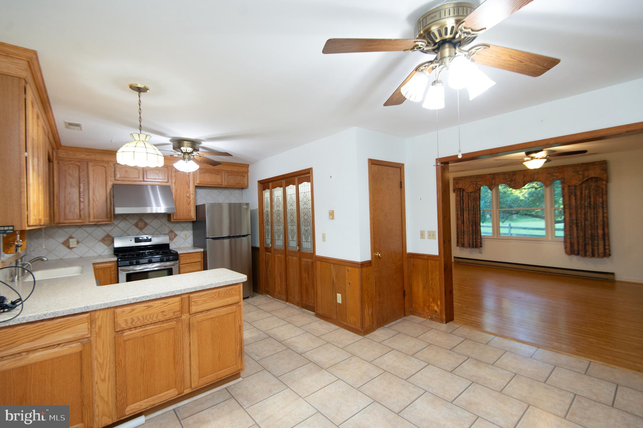 11482 Kittys Corner Road Cordova, MD 21625 - Photo 39 of 68 a kitchen with stainless steel appliances a sink stove and refrigerator