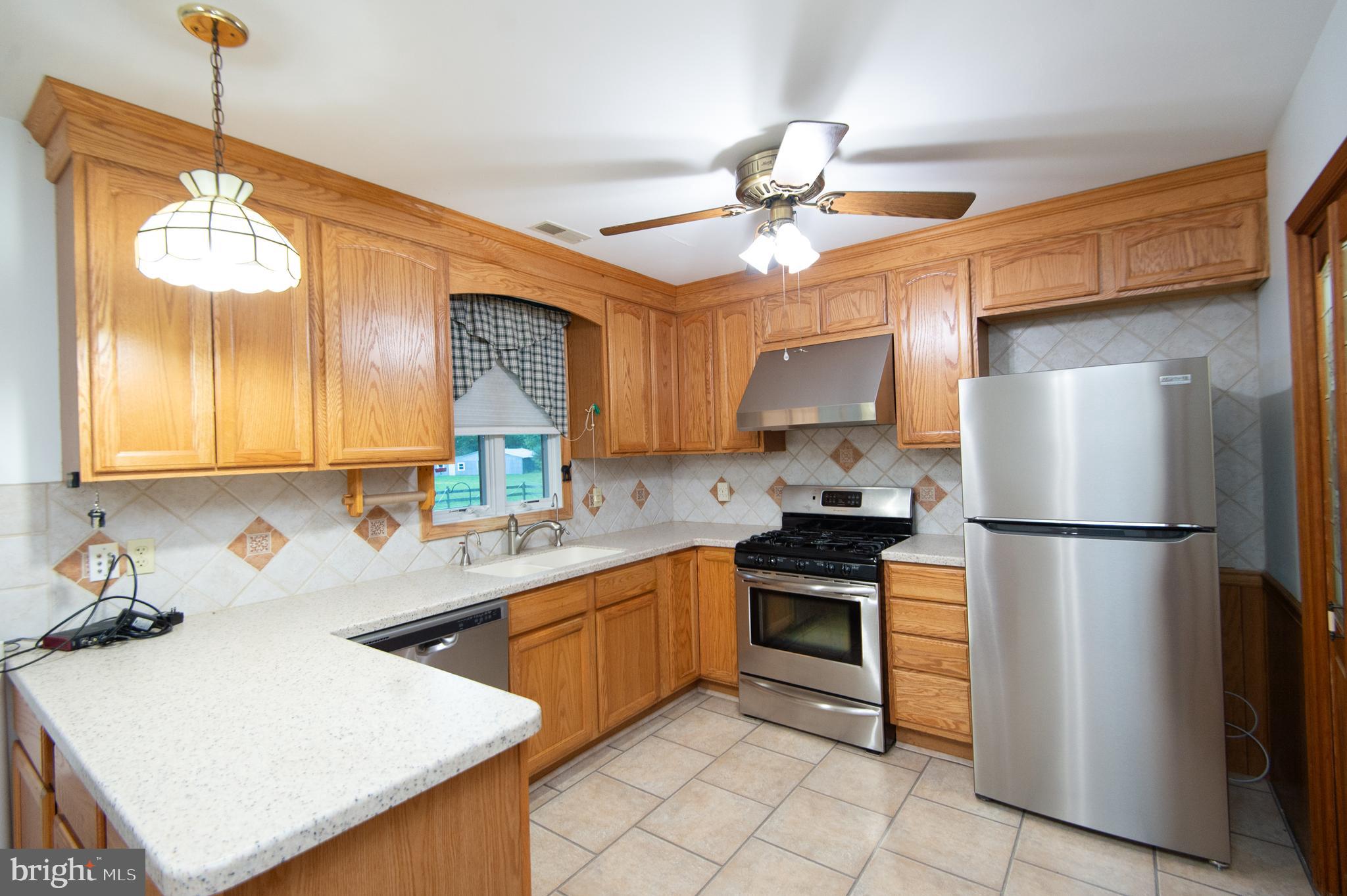 11482 Kittys Corner Road Cordova, MD 21625 - Photo 42 of 68 a kitchen with a sink appliances and cabinets