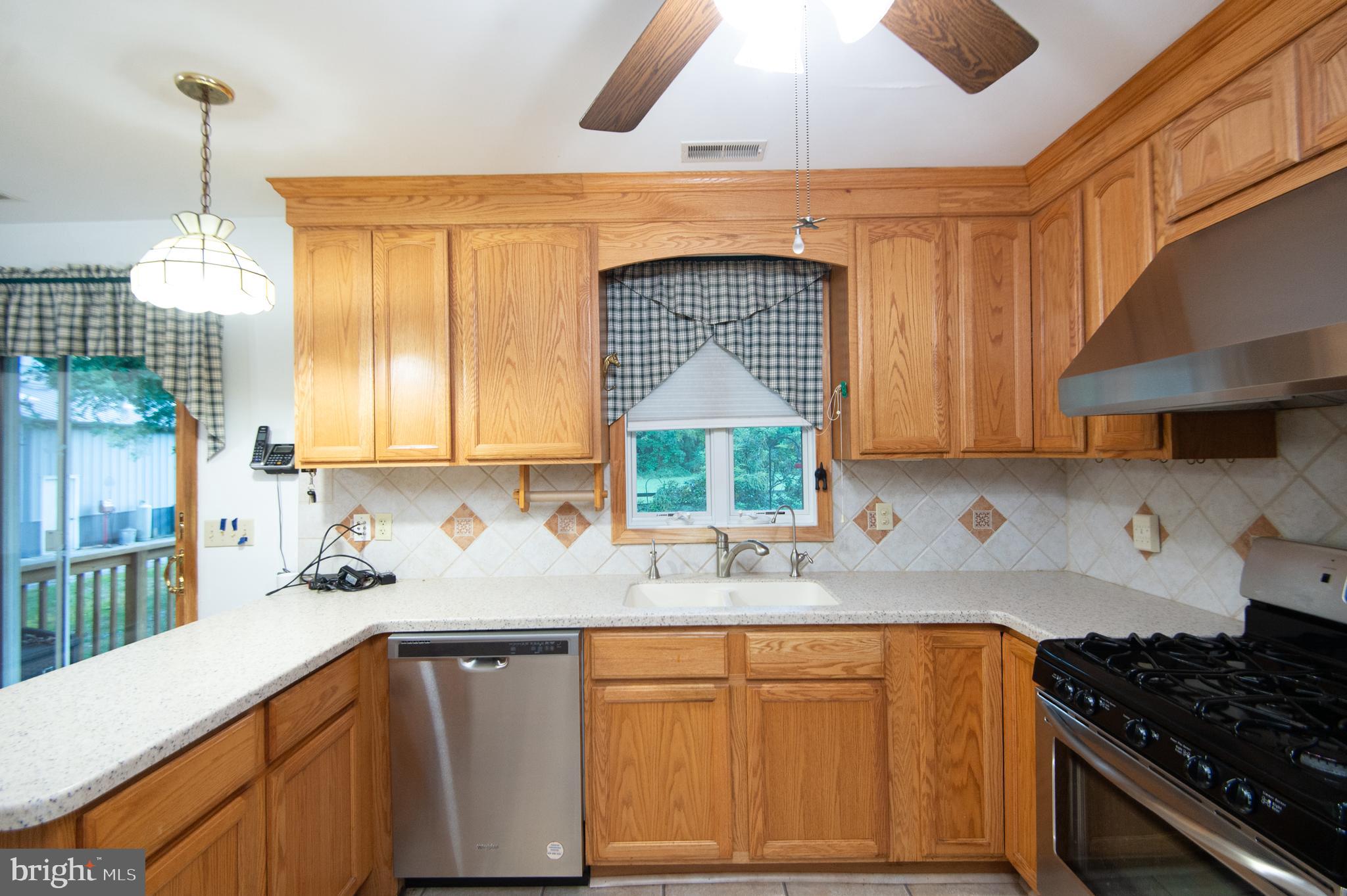 11482 Kittys Corner Road Cordova, MD 21625 - Photo 43 of 68 a kitchen with granite countertop a sink a stove and cabinets