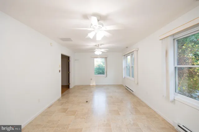 a view of empty room with wooden floor
