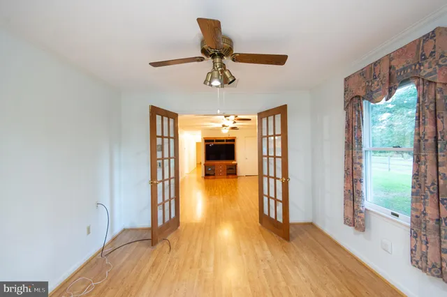 wooden floor in an empty room with a window