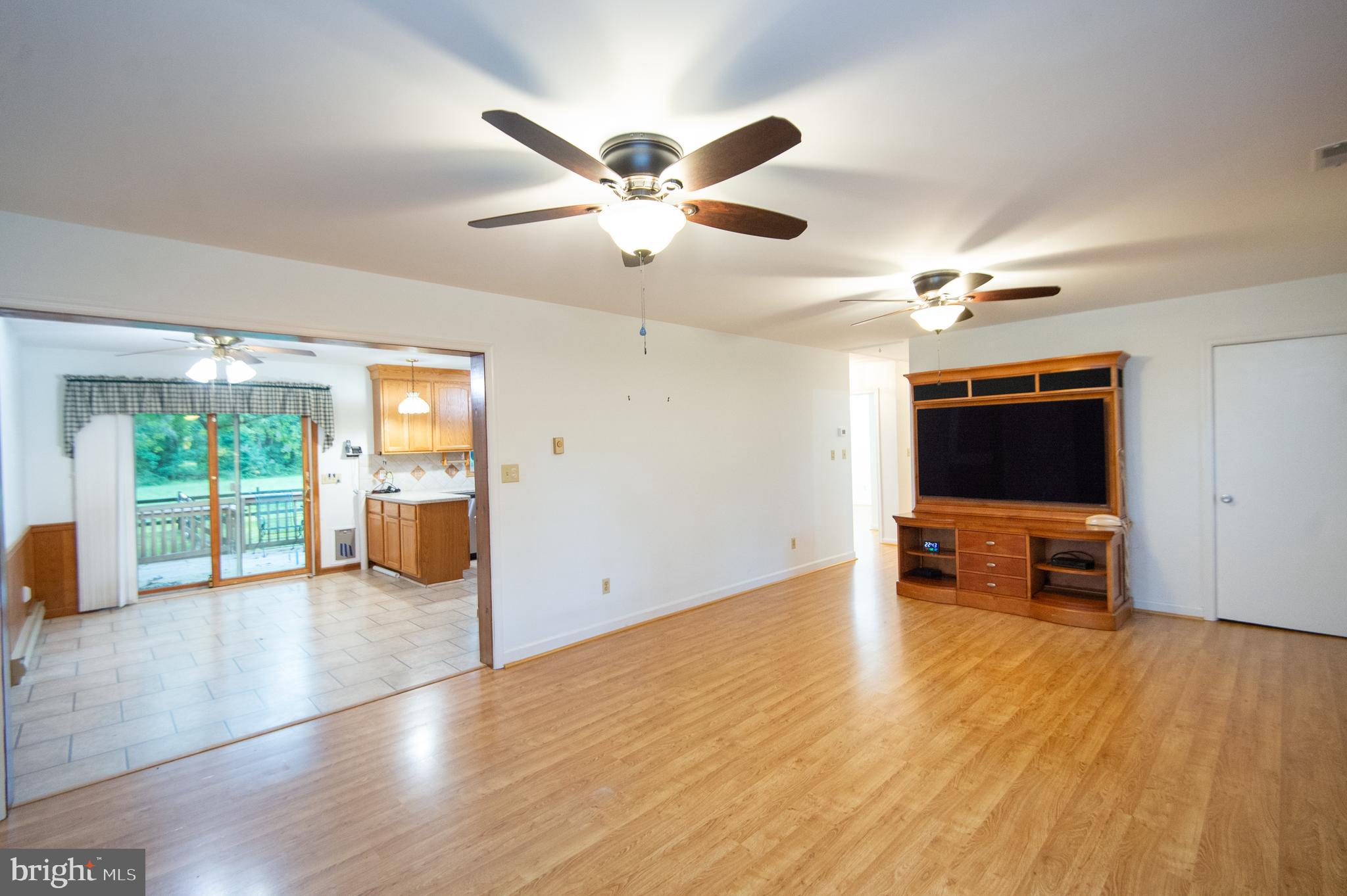 11482 Kittys Corner Road Cordova, MD 21625 - Photo 50 of 68 a view of an empty room with a window and a kitchen