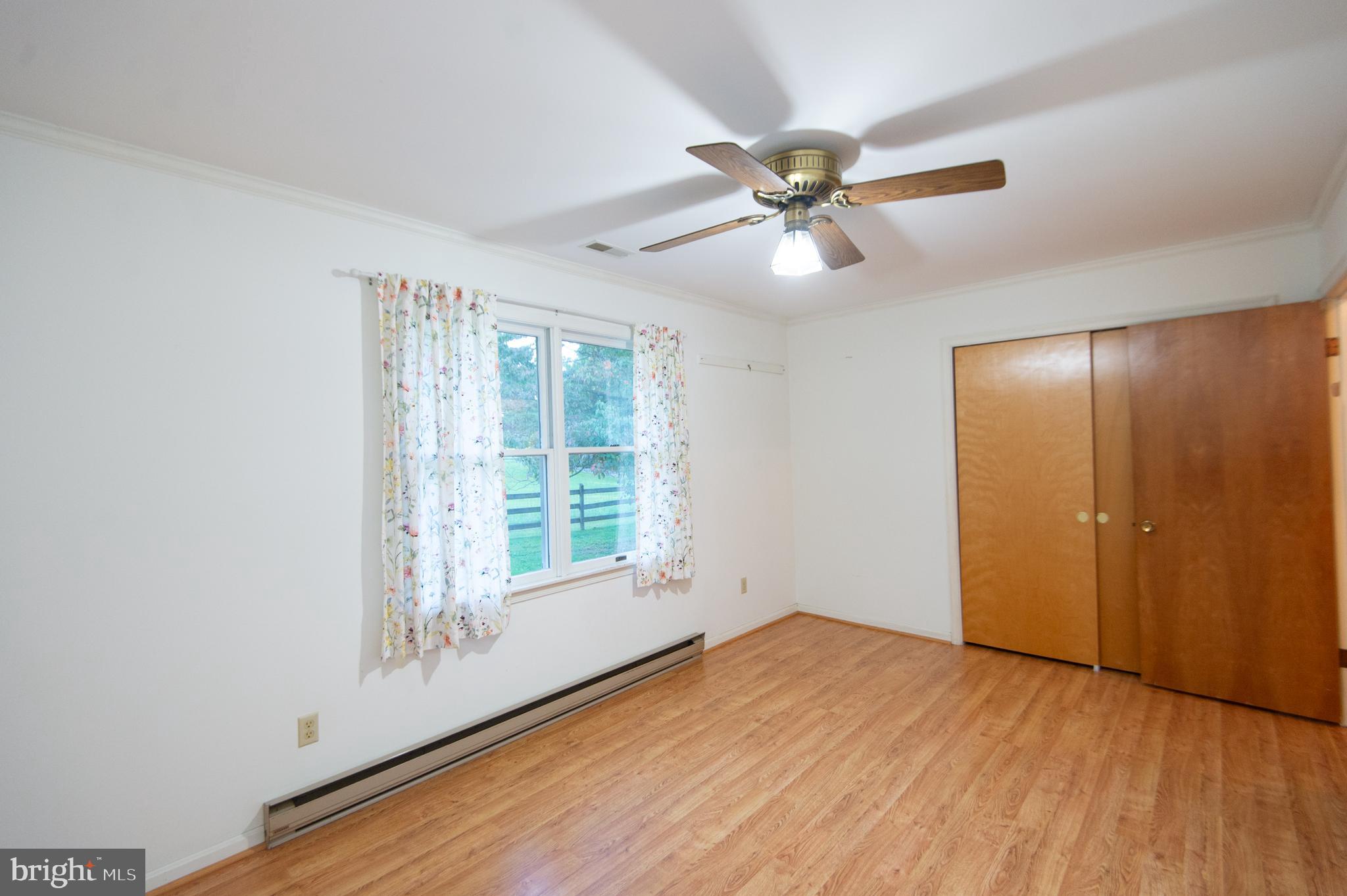 11482 Kittys Corner Road Cordova, MD 21625 - Photo 62 of 68 a view of an empty room with a window and wooden floor
