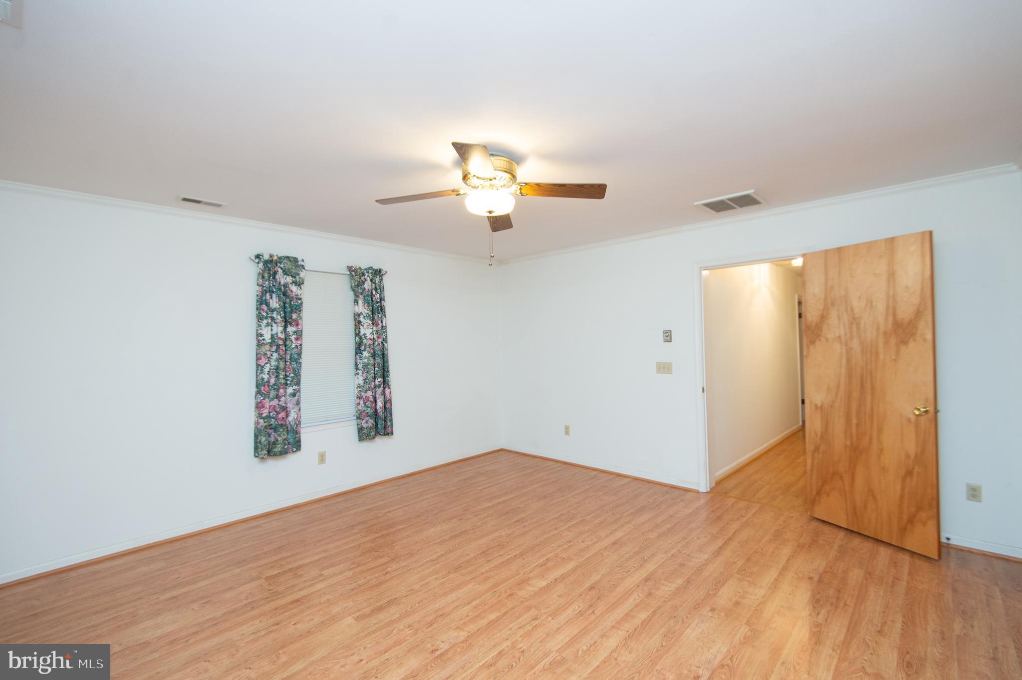 11482 Kittys Corner Road Cordova, MD 21625 - Photo 65 of 68 wooden floor in an empty room with a window