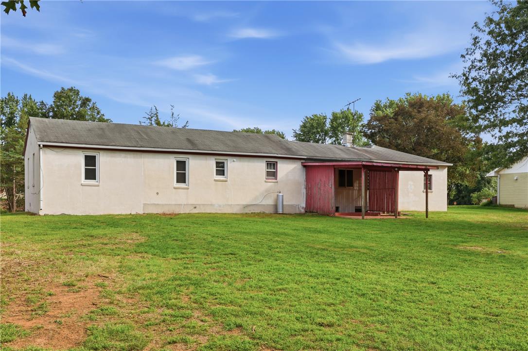 1033 Walt Road Pennsburg, PA 18073 - Photo 37 of 40 A spacious green lawn borders the rear of this single-story home featuring a covered patio.