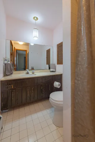 a bathroom with a sink a toilet and mirror