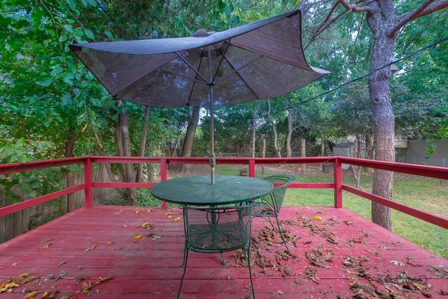 a view of a wooden deck and a backyard