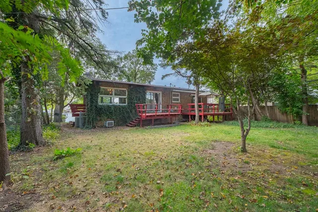 a view of a house with a backyard