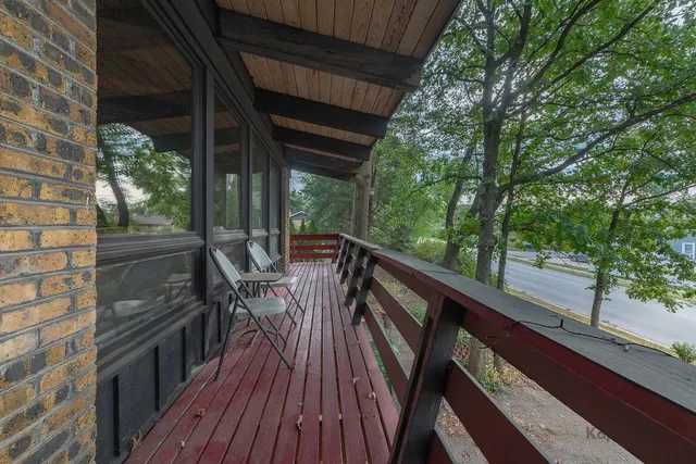a view of balcony with chairs and wooden fence