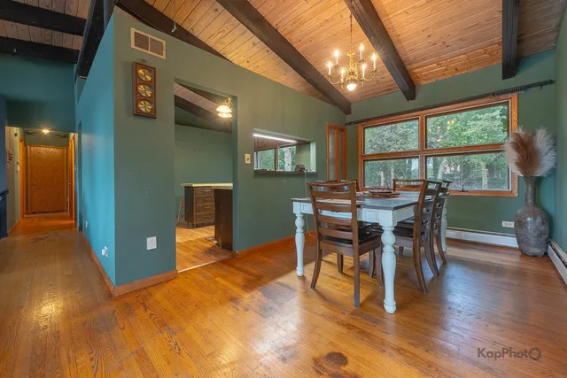 a view of a dining room with furniture and wooden floor