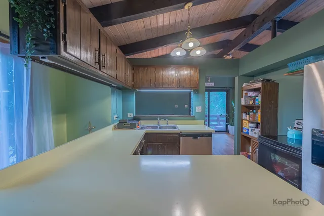 a kitchen with lots of counter top space and stainless steel appliances