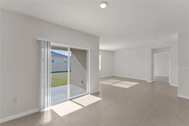 an empty room with a bathroom and a shower