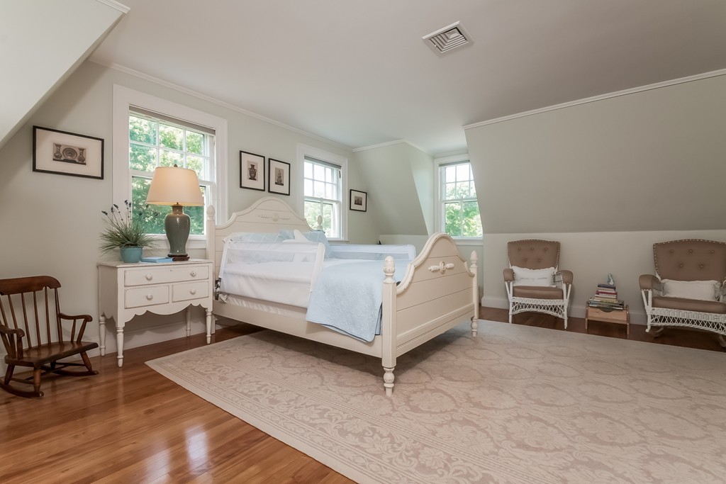 53 Tupelo Road Swampscott, MA 01907 - Photo 18 of 28 a bedroom with a bed a table and chair