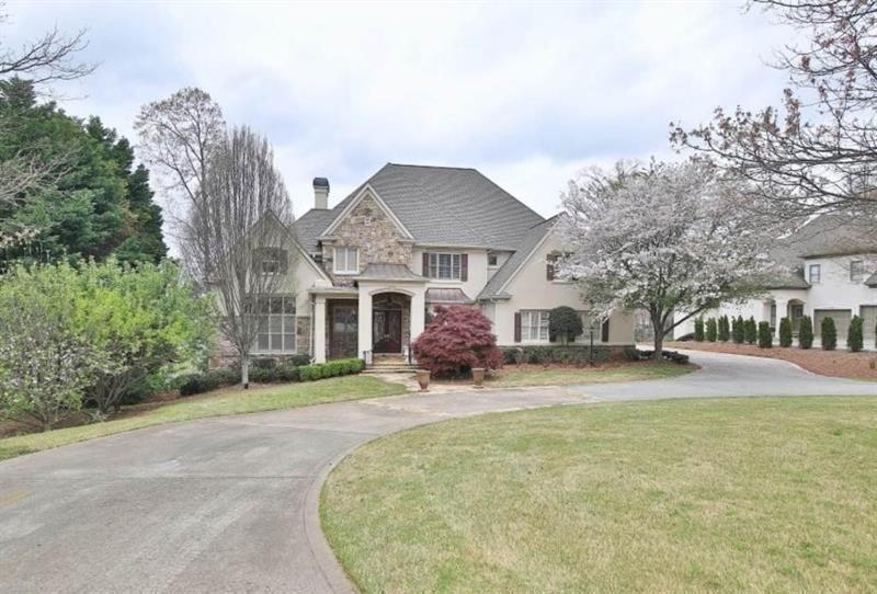 2737 Tarva Place Duluth, GA 30097 - Photo 1 of 33 a front view of a house with a yard and garage