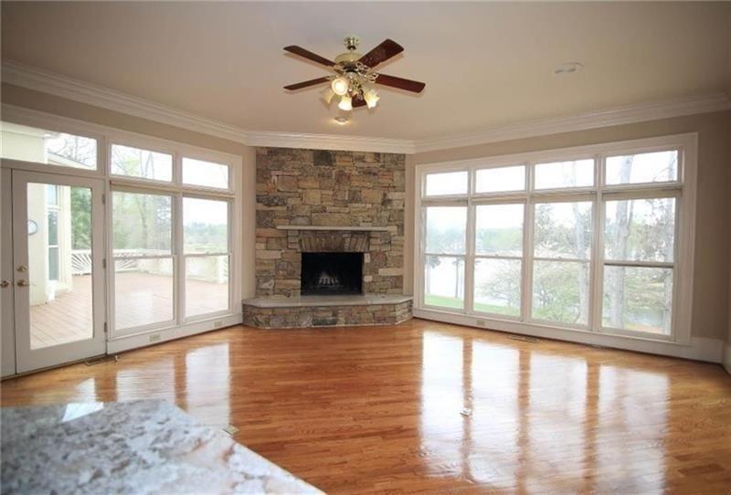 2737 Tarva Place Duluth, GA 30097 - Photo 6 of 33 a view of an empty room with a window and wooden floor