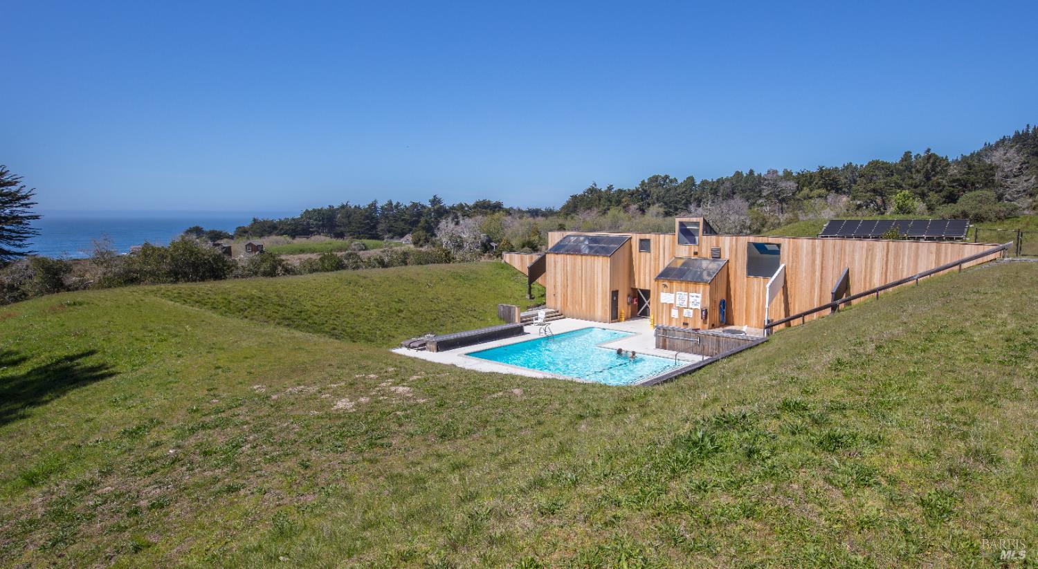 41179 Deer Trail The Sea Ranch, CA 95497 - Photo 31 of 33 a view of a swimming pool with a yard and large trees