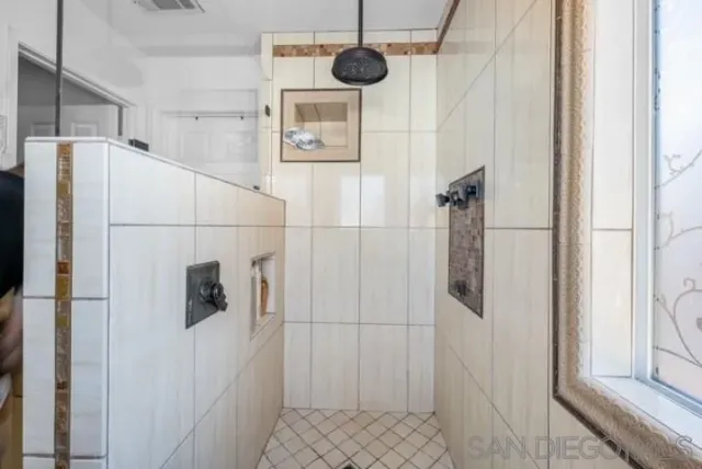 a bathroom with a shower and a sink
