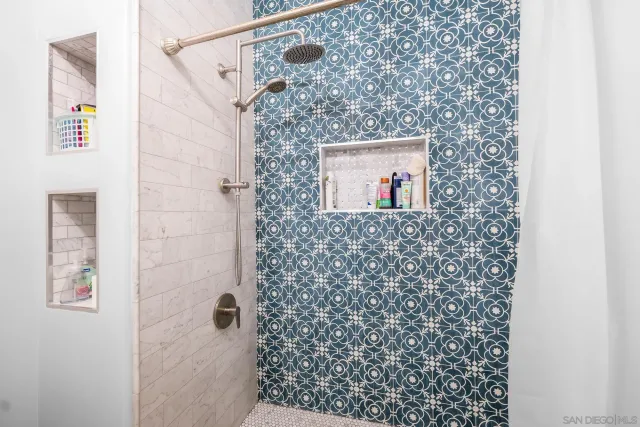 a bathroom with a shower and a mirror
