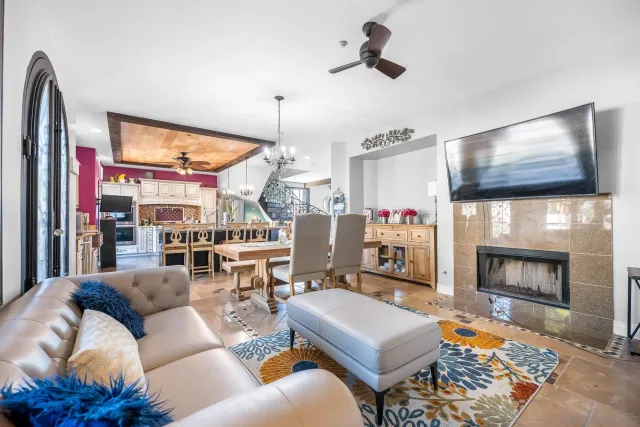 a living room with furniture a flat screen tv and a fireplace