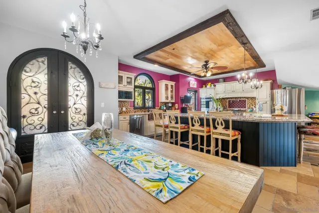 a living room with fireplace furniture and a large window