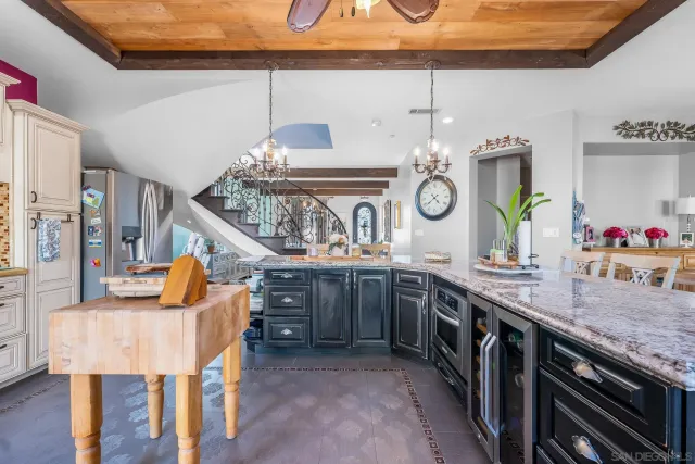 a kitchen with stainless steel appliances granite countertop a sink and a wooden floors
