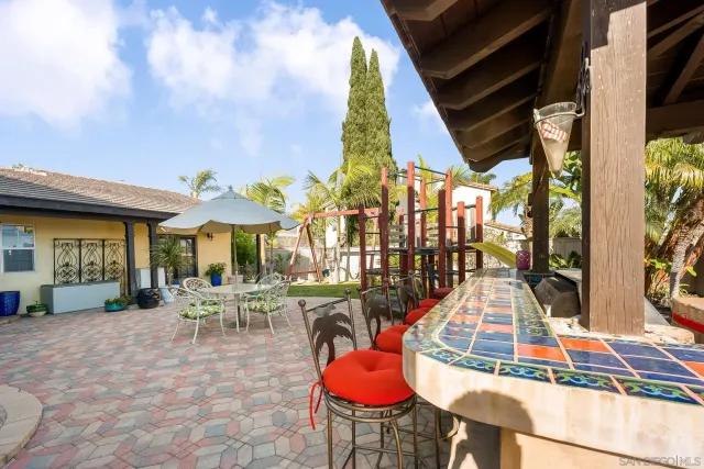 a view of a patio with table and chairs potted plants with wooden floor