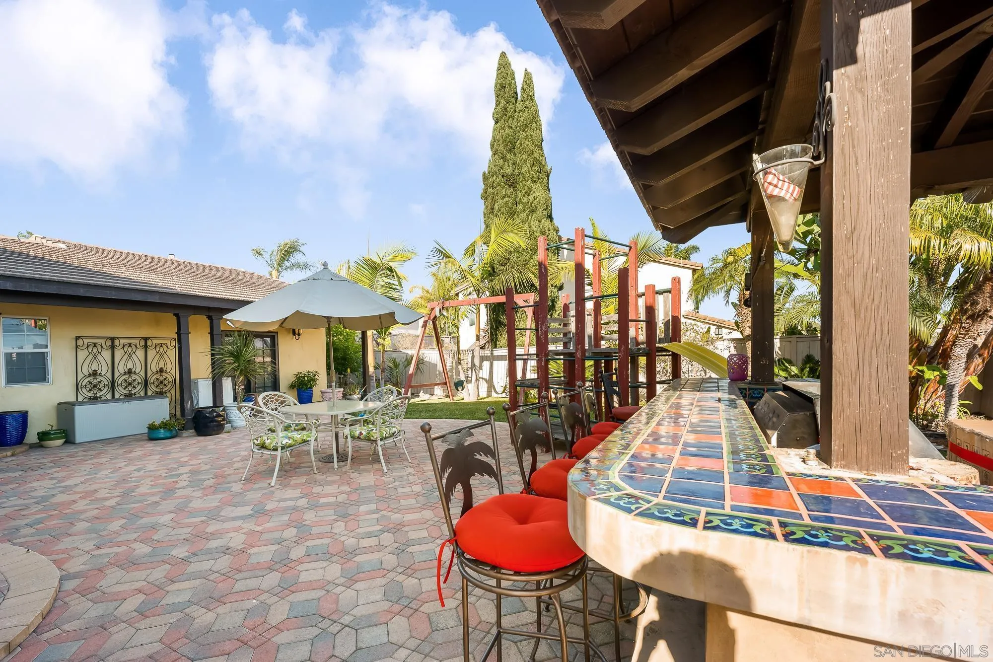 523 Hatherly Street Vista, CA 92083 - Photo 24 of 36 a view of a patio with table and chairs potted plants with wooden floor