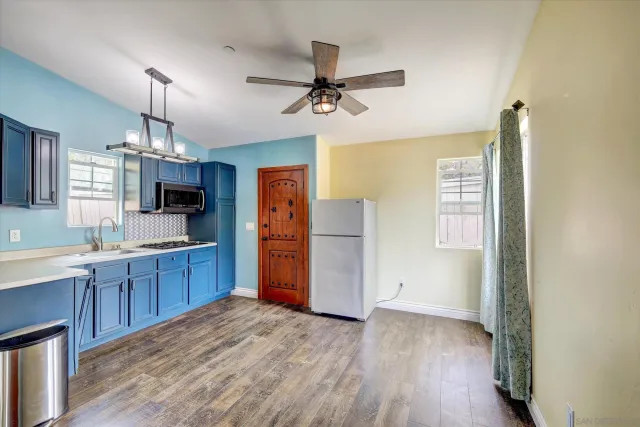 a kitchen with stainless steel appliances a refrigerator and a sink