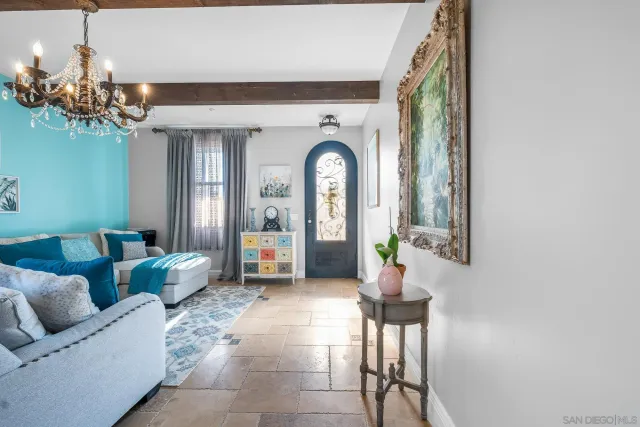 a living room with furniture and a chandelier