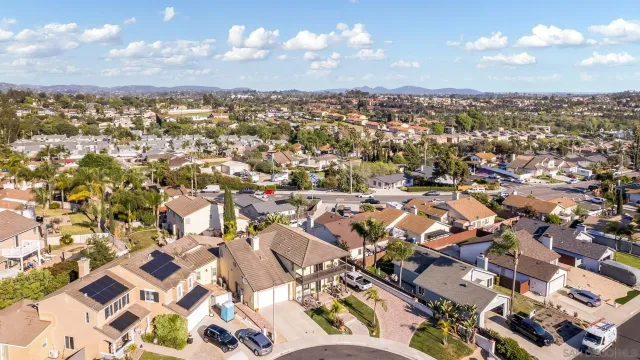 an aerial view of residential houses with city view